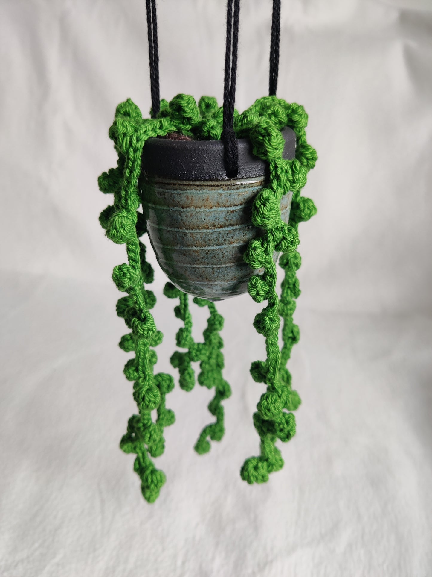 Hanging pot with crocheted pea plant